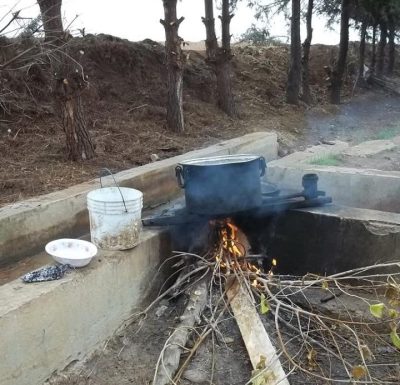 Dinner on the fire. Also the most common way to wash in Rojava.