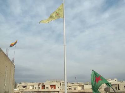 Flags fly in Central Kobane. They compete with an equally large Turkish flag that flies across the border north of the city.